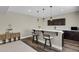 Basement bar area with barstool seating and modern pendant lighting at 1180 Ascent Trail Cir, Erie, CO 80516