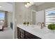 Well-lit bathroom featuring double sinks, modern fixtures, and stylish vanity at 1180 Ascent Trail Cir, Erie, CO 80516