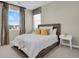 Bright bedroom featuring large window, neutral tones, and modern decor at 1180 Ascent Trail Cir, Erie, CO 80516