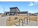 Exterior of the modern community clubhouse featuring stone accents, bike racks, and manicured landscaping at 1180 Ascent Trail Cir, Erie, CO 80516