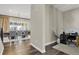 Open hallway featuring hardwood floors, a dining room view, and a home office setup to the side at 1180 Ascent Trail Cir, Erie, CO 80516