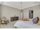 Bright main bedroom featuring tray ceiling, modern chandelier, and ensuite bathroom at 1180 Ascent Trail Cir, Erie, CO 80516