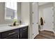 Mudroom with counter space, cabinets, a window, and easy access to both the garage and the interior of the home at 1180 Ascent Trail Cir, Erie, CO 80516