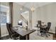 Home office with dual workstations, dark wood desks, and a view of the staircase at 1180 Ascent Trail Cir, Erie, CO 80516