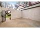 Enclosed back patio with an arched entrance, stucco walls, and concrete flooring at 1321 Madero St, Broomfield, CO 80020