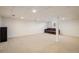 Expansive basement with recessed lights, carpet, and a support beam in the center at 1321 Madero St, Broomfield, CO 80020