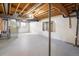 Unfinished basement space with exposed ductwork, white walls, and concrete flooring at 1321 Madero St, Broomfield, CO 80020