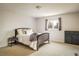 Comfortable bedroom with neutral walls, carpeting, and a window; furnished with bed, dresser, and nightstand at 1321 Madero St, Broomfield, CO 80020