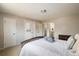 Bright bedroom showcases access doors and ensuite bathroom with white linens and plush pillows at 1321 Madero St, Broomfield, CO 80020