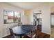 Bright dining room with a view, featuring a modern light fixture and seamless transition to the kitchen at 1321 Madero St, Broomfield, CO 80020
