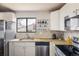 Modern kitchen featuring stainless steel appliances, granite countertops, and a bright, airy feel at 1321 Madero St, Broomfield, CO 80020