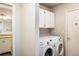 Convenient laundry room features a side-by-side washer and dryer, as well as overhead storage cabinets at 1321 Madero St, Broomfield, CO 80020