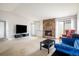 Cozy living room with a stone fireplace, plush seating, and sliding glass doors for natural light at 1321 Madero St, Broomfield, CO 80020