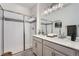 Bathroom featuring a double vanity and glass shower enclosure at 26902 E Ellsworth Ave, Aurora, CO 80018