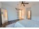 A bright bedroom featuring a barn door, a ceiling fan, and a full length mirror at 26902 E Ellsworth Ave, Aurora, CO 80018