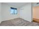 Cozy bedroom with large window, soft carpet, and closet space at 26902 E Ellsworth Ave, Aurora, CO 80018
