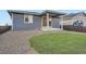 Back of house view with patio, small lawn and landscaping at 26902 E Ellsworth Ave, Aurora, CO 80018