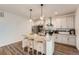 Bright kitchen features an island with seating and stylish pendant lighting at 26902 E Ellsworth Ave, Aurora, CO 80018