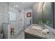 Modern bathroom featuring a granite countertop vanity and a glass-enclosed shower at 9230 Lombardy Ln, Denver, CO 80215