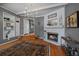 Open concept dining room with fireplace, built-in shelving, and kitchen access at 9230 Lombardy Ln, Denver, CO 80215