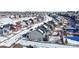 Aerial view showcases a residential neighborhood with similar two-story homes and snow-covered yards at 4808 Point Mesa St, Castle Rock, CO 80108