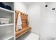 Functional bathroom with a built-in bench, hooks, and shelving for storage at 534 W Meadow Rd, Evergreen, CO 80439
