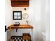 Charming bathroom with a wooden countertop sink and black and white checkered flooring at 534 W Meadow Rd, Evergreen, CO 80439