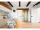 Bedroom featuring a bunk bed and a bathroom with a sliding barn door entrance at 534 W Meadow Rd, Evergreen, CO 80439