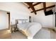 Bright and airy primary bedroom with vaulted ceilings, wood beams, hardwood floors and plenty of natural light at 534 W Meadow Rd, Evergreen, CO 80439