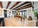 A spacious dining room featuring a large table, light wood floors, and wooden beams at 534 W Meadow Rd, Evergreen, CO 80439
