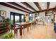 Elegant dining room boasting wood beams, a stone fireplace, and an open floor plan at 534 W Meadow Rd, Evergreen, CO 80439