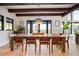 Beautiful dining room featuring natural light, wood beams, and access to an outdoor deck at 534 W Meadow Rd, Evergreen, CO 80439