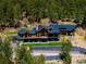 Beautiful mountain home featuring natural wood construction and a lovely stone retaining wall and professional landscaping at 534 W Meadow Rd, Evergreen, CO 80439