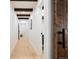Bright hallway featuring hardwood floors, recessed lighting, wood beam accents, and access to other rooms at 534 W Meadow Rd, Evergreen, CO 80439
