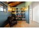 Comfortable home office with custom built-in shelves and cozy reading chair at 534 W Meadow Rd, Evergreen, CO 80439
