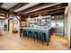 Open kitchen with an island, counter seating, stainless appliances, and striking wood beam accents at 534 W Meadow Rd, Evergreen, CO 80439