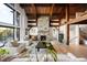 Open concept living area with hardwood floors, stone fireplace and large windows offering an abundance of natural light at 534 W Meadow Rd, Evergreen, CO 80439