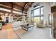 Spacious living room boasts soaring ceilings, exposed beams, floor to ceiling windows and comfortable seating at 534 W Meadow Rd, Evergreen, CO 80439