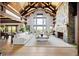 Bright living room features vaulted ceilings, a stone fireplace, hardwood floors, and large windows with beautiful views at 534 W Meadow Rd, Evergreen, CO 80439