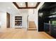 Open living space with hardwood floors, a bookshelf, and a custom wet bar at 534 W Meadow Rd, Evergreen, CO 80439