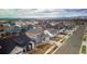 Picturesque aerial view of a neighborhood featuring modern homes and scenic mountain views in the distance at 605 Wild Honey Dr, Berthoud, CO 80513