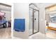 Bathroom features walk-in closet, glass shower and view into the bedroom at 605 Wild Honey Dr, Berthoud, CO 80513