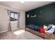 This room has a twin bed and dark green accent wall at 605 Wild Honey Dr, Berthoud, CO 80513