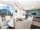 Elegant dining area featuring a rustic wood table, comfortable seating, and sliding glass doors at 605 Wild Honey Dr, Berthoud, CO 80513