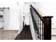 Inviting entryway with hardwood floors, a staircase, and a sliding barn door to the kitchen at 605 Wild Honey Dr, Berthoud, CO 80513