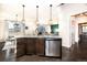 Stylish kitchen island with granite countertops, pendant lighting, and stainless steel appliances at 605 Wild Honey Dr, Berthoud, CO 80513
