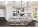 Bright kitchen with white cabinets, granite countertops, and a stainless steel appliance package at 605 Wild Honey Dr, Berthoud, CO 80513