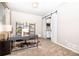 Cozy office with modern decor, natural light, and a sliding barn door leading to the kitchen at 605 Wild Honey Dr, Berthoud, CO 80513