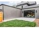 Modern backyard with an outdoor living space and grassy area, perfect for relaxing at 1665 S Fillmore St, Denver, CO 80210