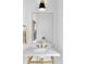 Modern bathroom features marble countertop, gold faucet, and sleek light fixture at 1665 S Fillmore St, Denver, CO 80210